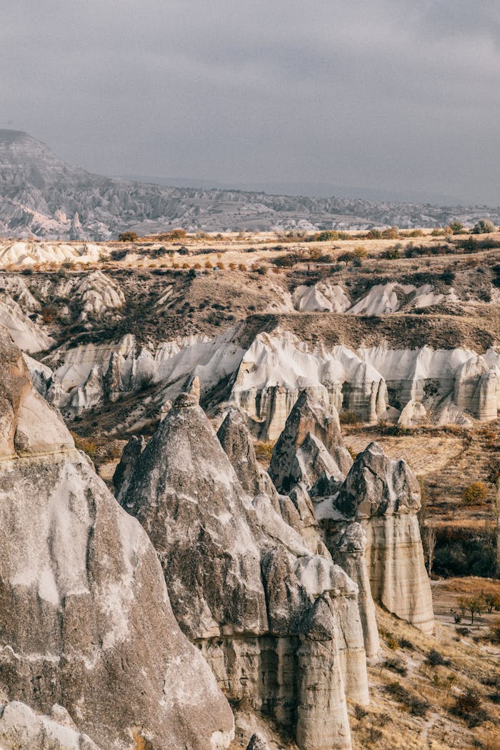 High angle amazing view of rough rocky volcanic formations in highlands in overcast weather in Cappadocia